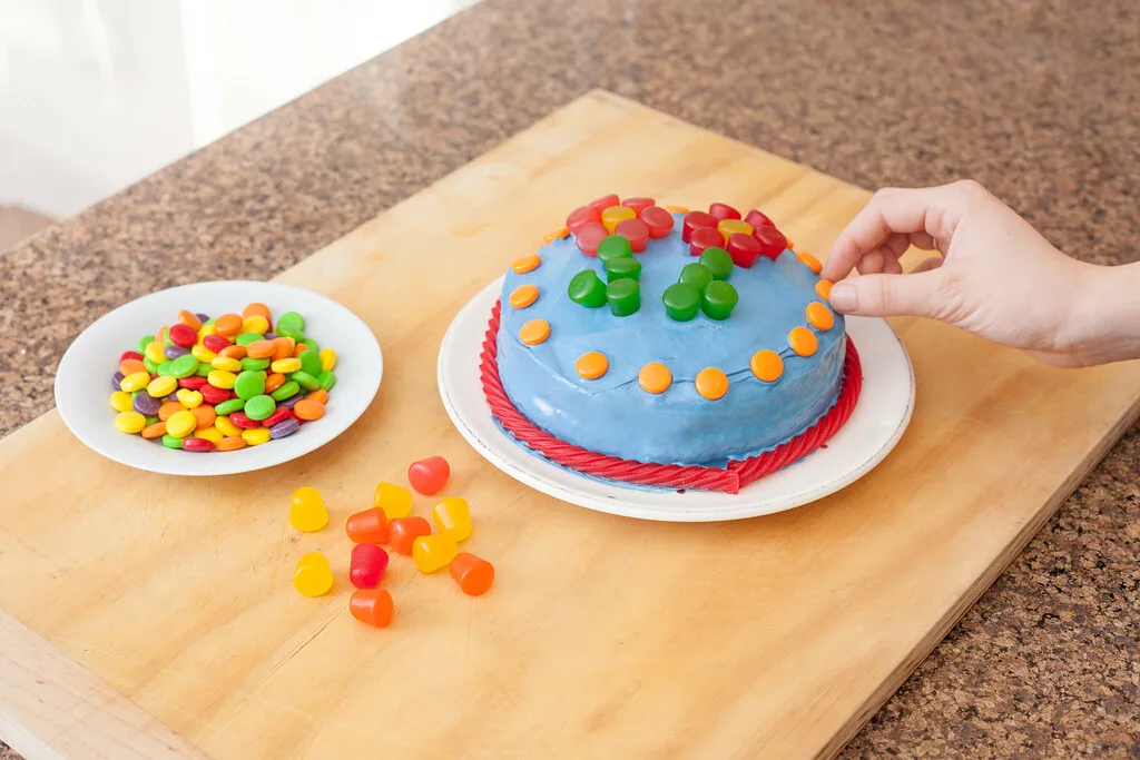 Child blowing out birthday cake candles